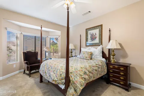 a bedroom with a bed chair and bed