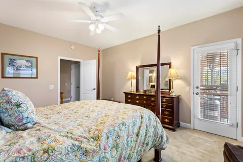 a bedroom with a large bed and a chandelier