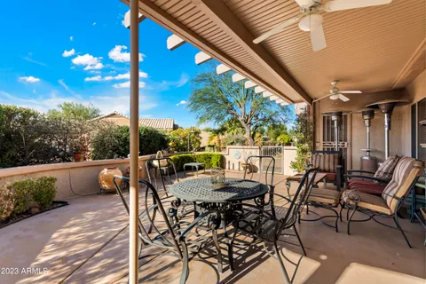 a view of an outdoor dining space with furniture and garden view