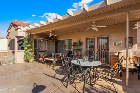 a view of a patio with dining table and chairs with plants
