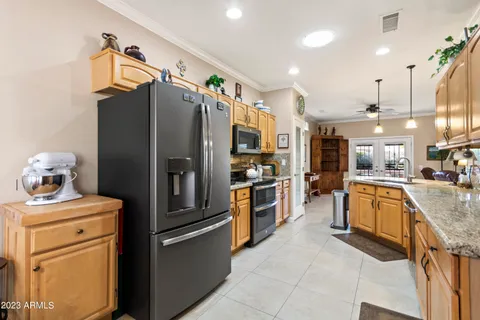 a kitchen with stainless steel appliances granite countertop a refrigerator and a sink