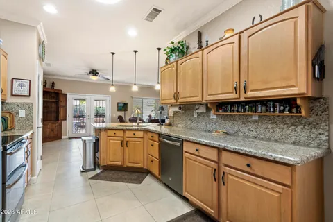 a kitchen with stainless steel appliances granite countertop a sink a stove and cabinets