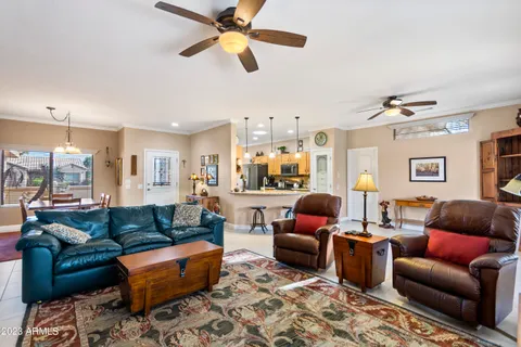 a living room with furniture a ceiling fan and a rug