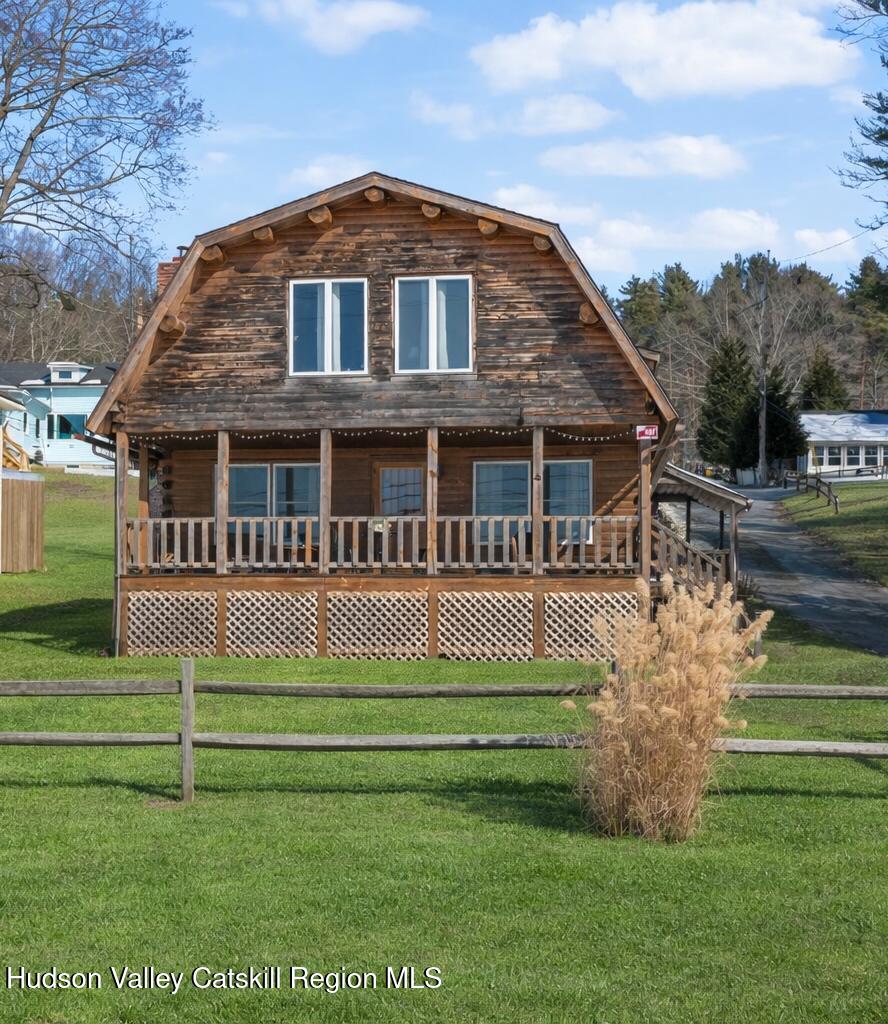 a front view of a house with a yard table and chairs
