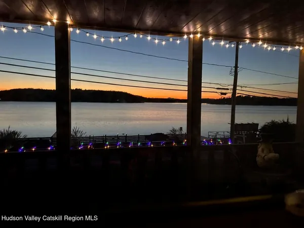 a bathroom with a granite countertop toilet and a sink