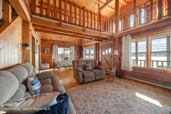 a view of a balcony with chairs and wooden floor