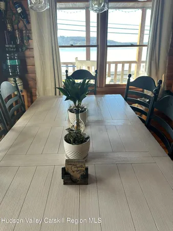 a dining room with furniture a chandelier and wooden floor