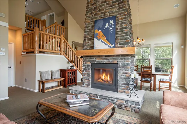 a living room with furniture a window and a fireplace