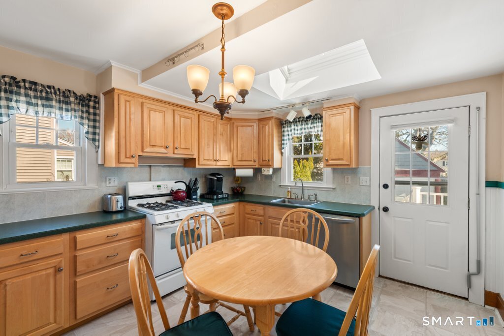 75 Elizabeth Terrace Stratford, CT 06614 - Photo 18 of 38 a kitchen that has cabinets a sink and chairs in it