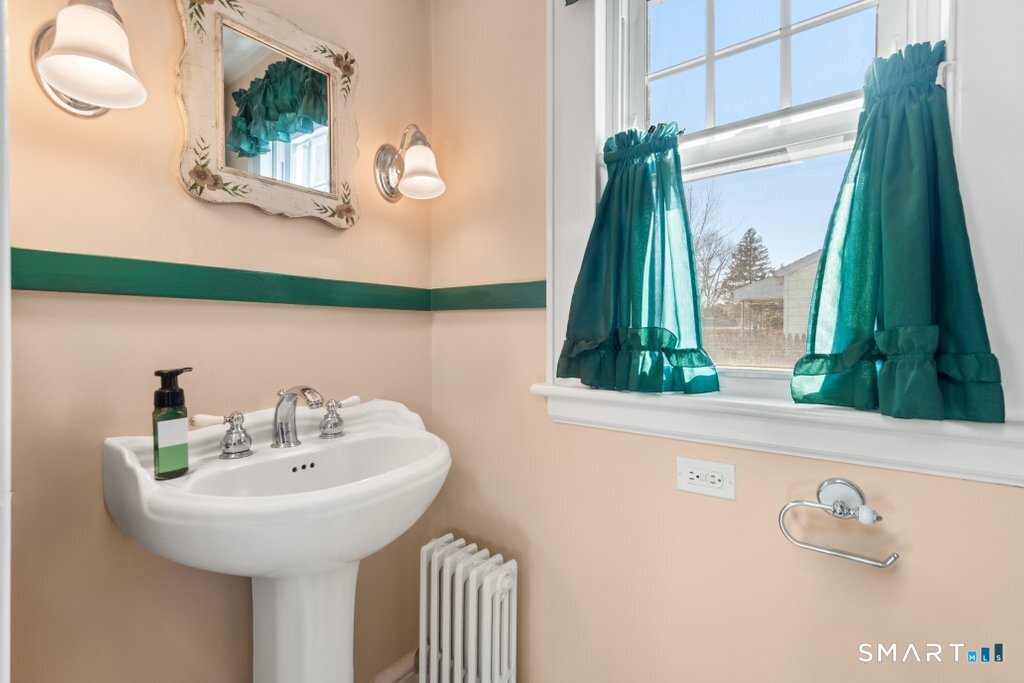 75 Elizabeth Terrace Stratford, CT 06614 - Photo 22 of 38 a bathroom with a sink and a mirror