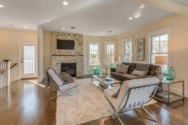 a living room with furniture fireplace and flat screen tv
