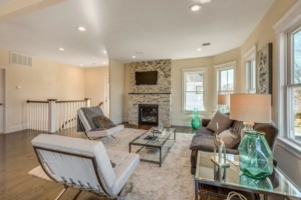 a living room with furniture fireplace and a flat screen tv