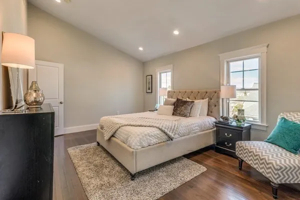 a bedroom with a bed and wooden floor