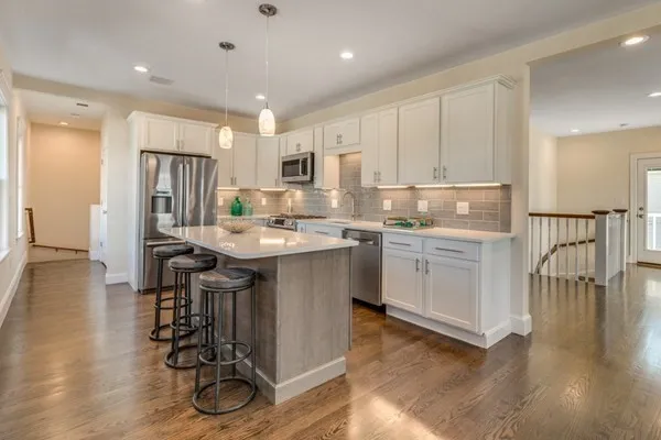 a kitchen with a sink appliances and cabinets