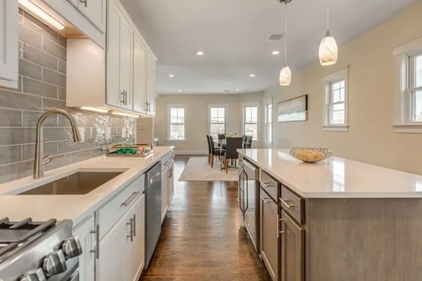 a kitchen with counter top space a sink and appliances