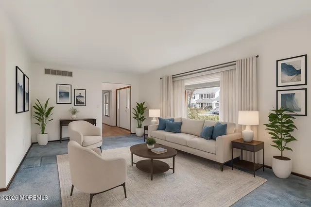 a living room with furniture and a potted plant