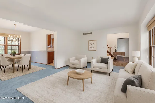 a living room with furniture and a dining table