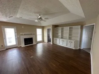 an empty room with wooden floor and fireplace