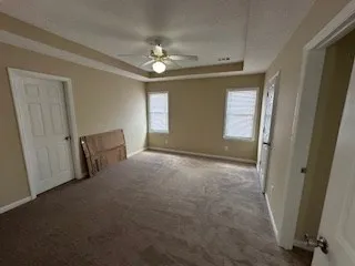 an empty room with windows and entrance