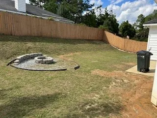 a backyard of a house with a yard and outdoor seating