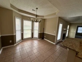 a view of a livingroom with a furniture and chandelier kitchen