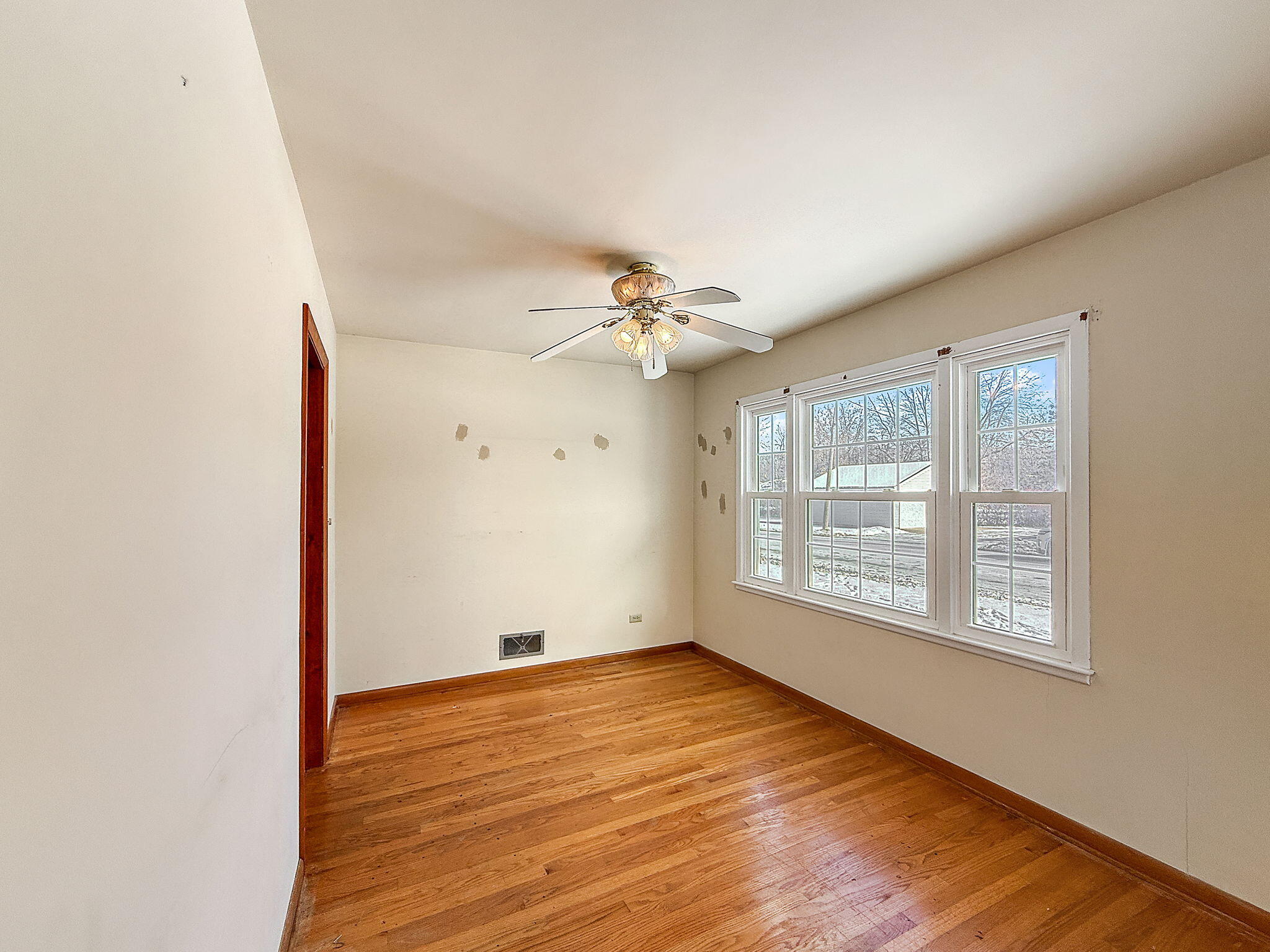 3339 Wirth Road Highland, IN 46322 - Photo 11 of 29 an empty room with wooden floor fan and windows