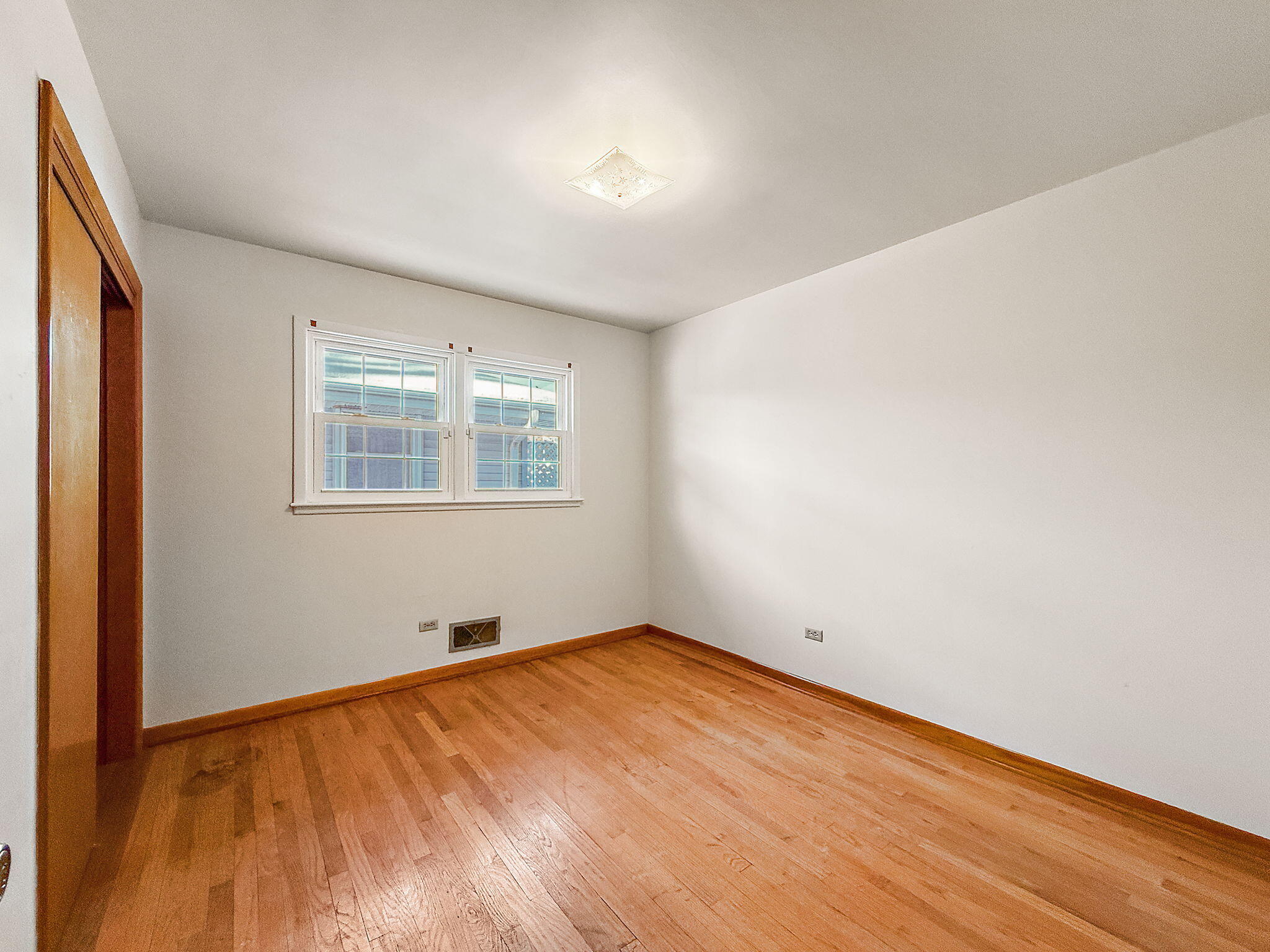 3339 Wirth Road Highland, IN 46322 - Photo 20 of 29 an empty room with wooden floor and windows