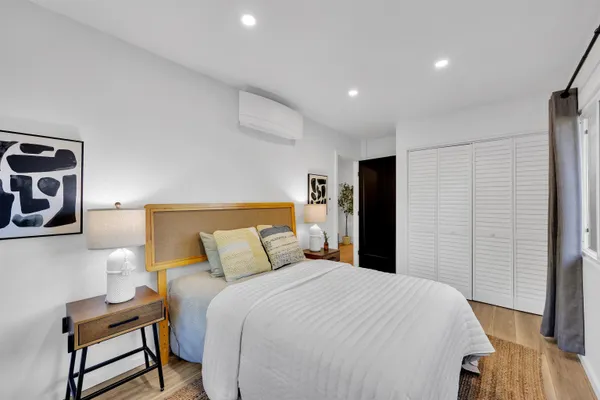 a bedroom with a bed and chair