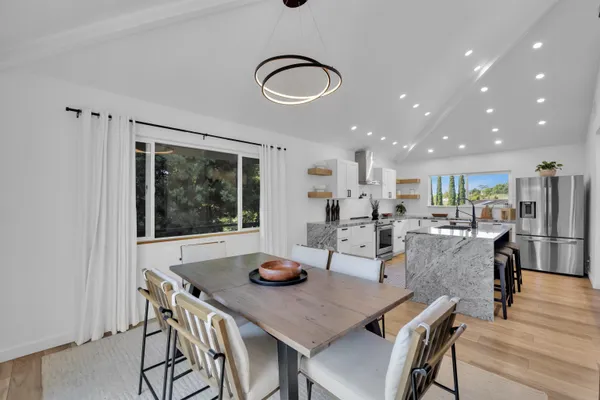 a view of a dining room with furniture and wooden floor