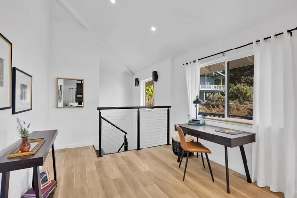 a view of a workspace with furniture and a window