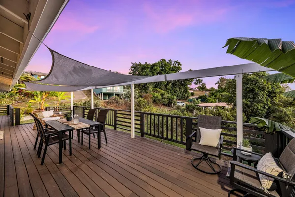 a view of a chair and table on the deck