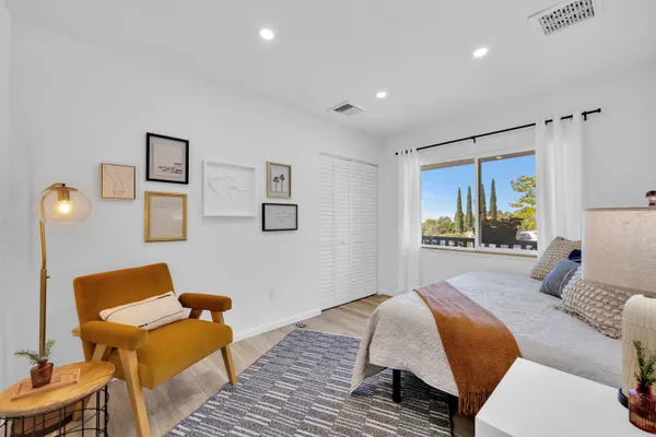 a bedroom with a bed and wooden floor