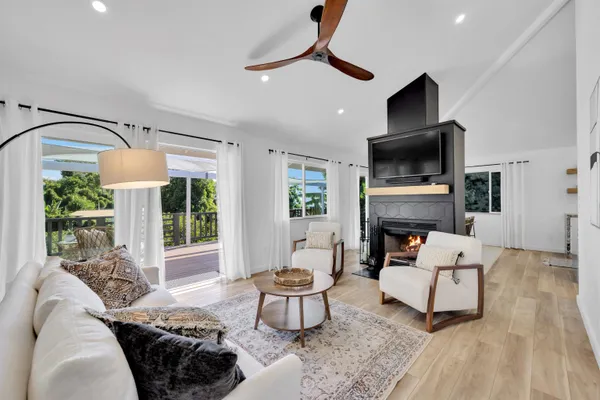 a living room with furniture a fireplace and a flat screen tv
