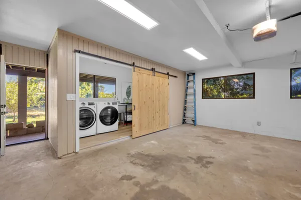 a view of a hallway with washer and dryer