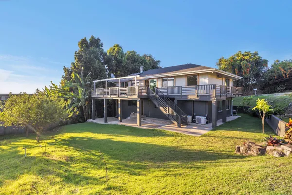 a view of a swimming pool with an outdoor seating and a yard