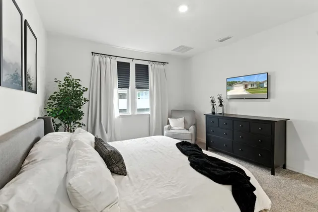 a room with a chair and a dresser