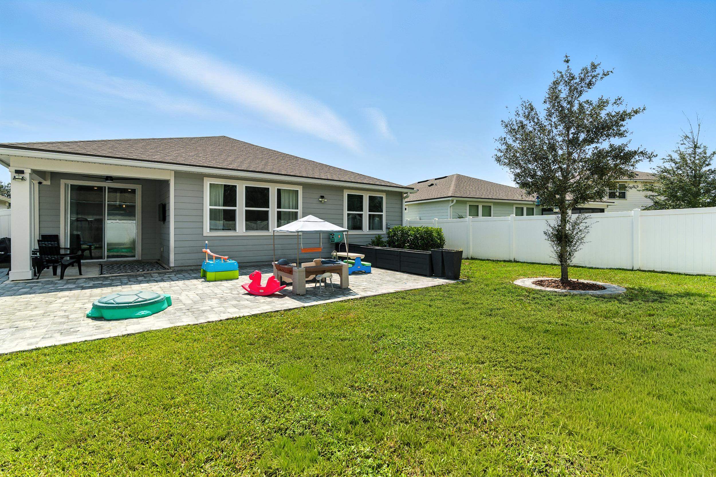 196 Red Barn Rd Street St. Augustine, FL 32092 - Photo 27 of 53 Back of house with a patio and a shingled roof
