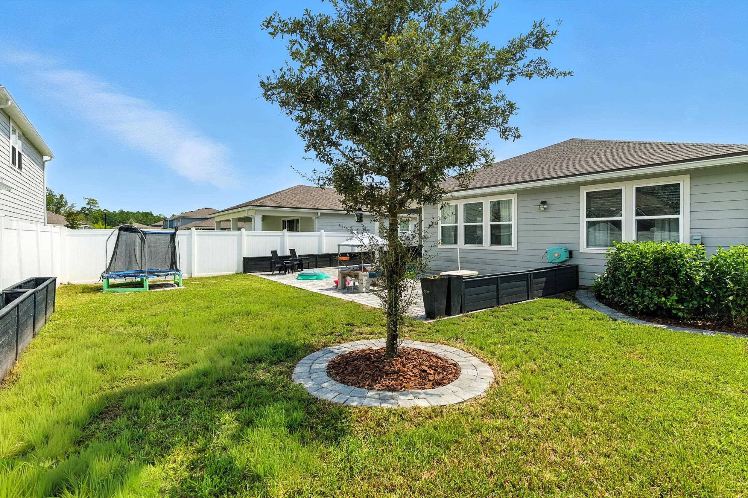 196 Red Barn Rd Street St. Augustine, FL 32092 - Photo 28 of 53 a front view of a house with a yard and trees