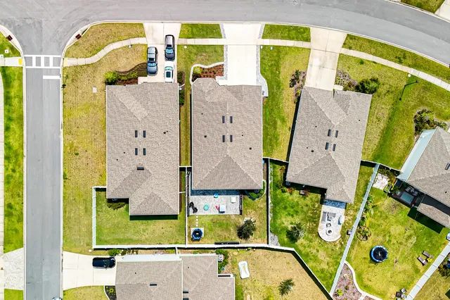 a front view of a house with swimming pool garden and patio