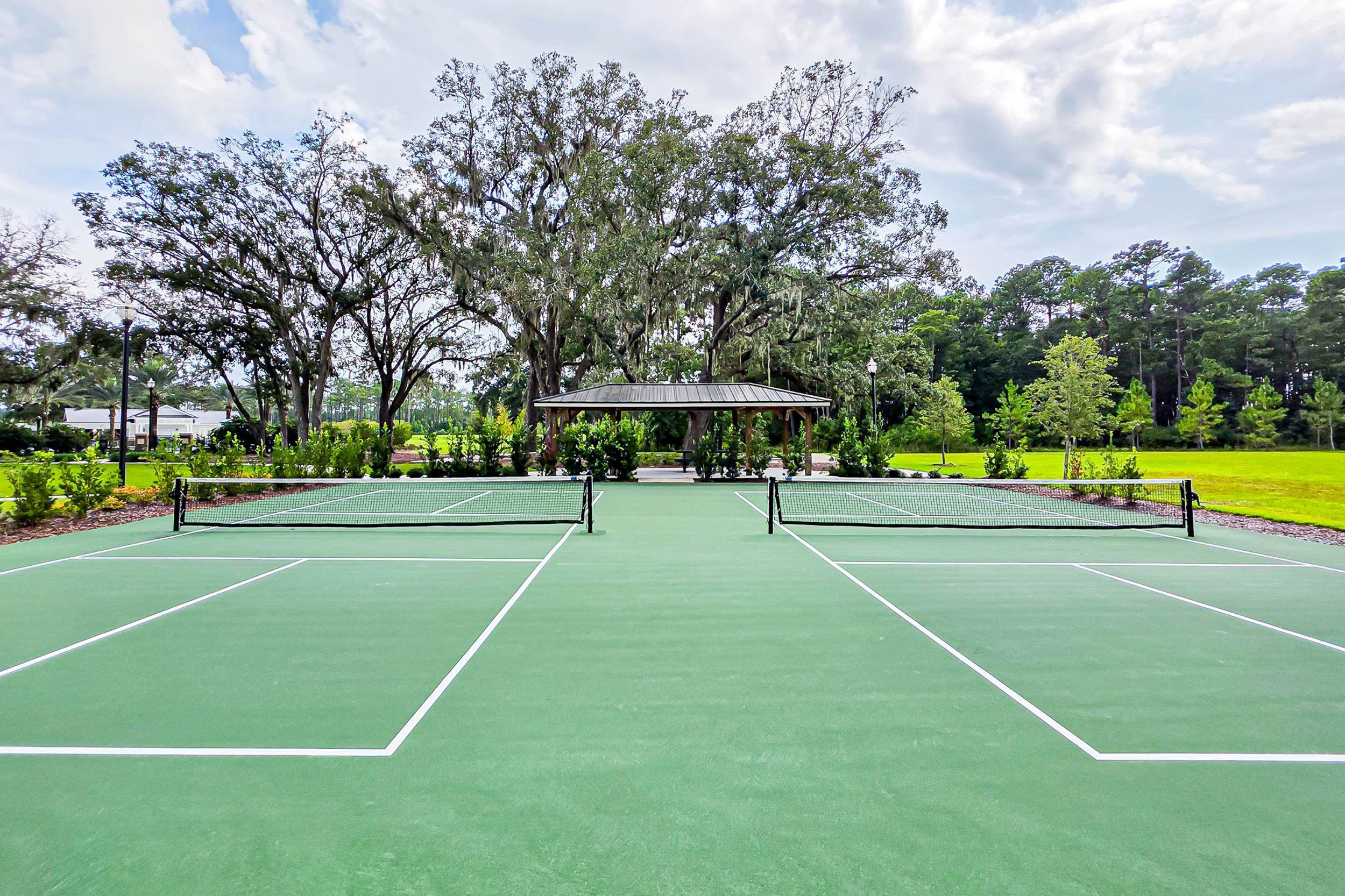 196 Red Barn Rd Street St. Augustine, FL 32092 - Photo 40 of 53 a view of a tennis ground with large trees
