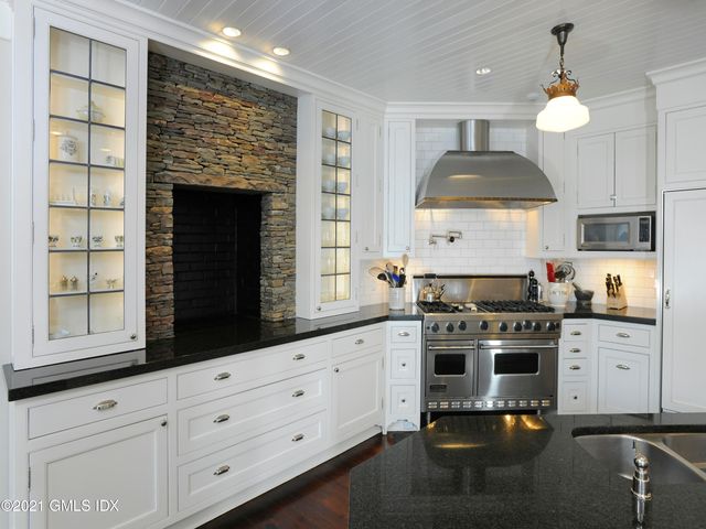 a kitchen with stainless steel appliances a stove and more cabinets