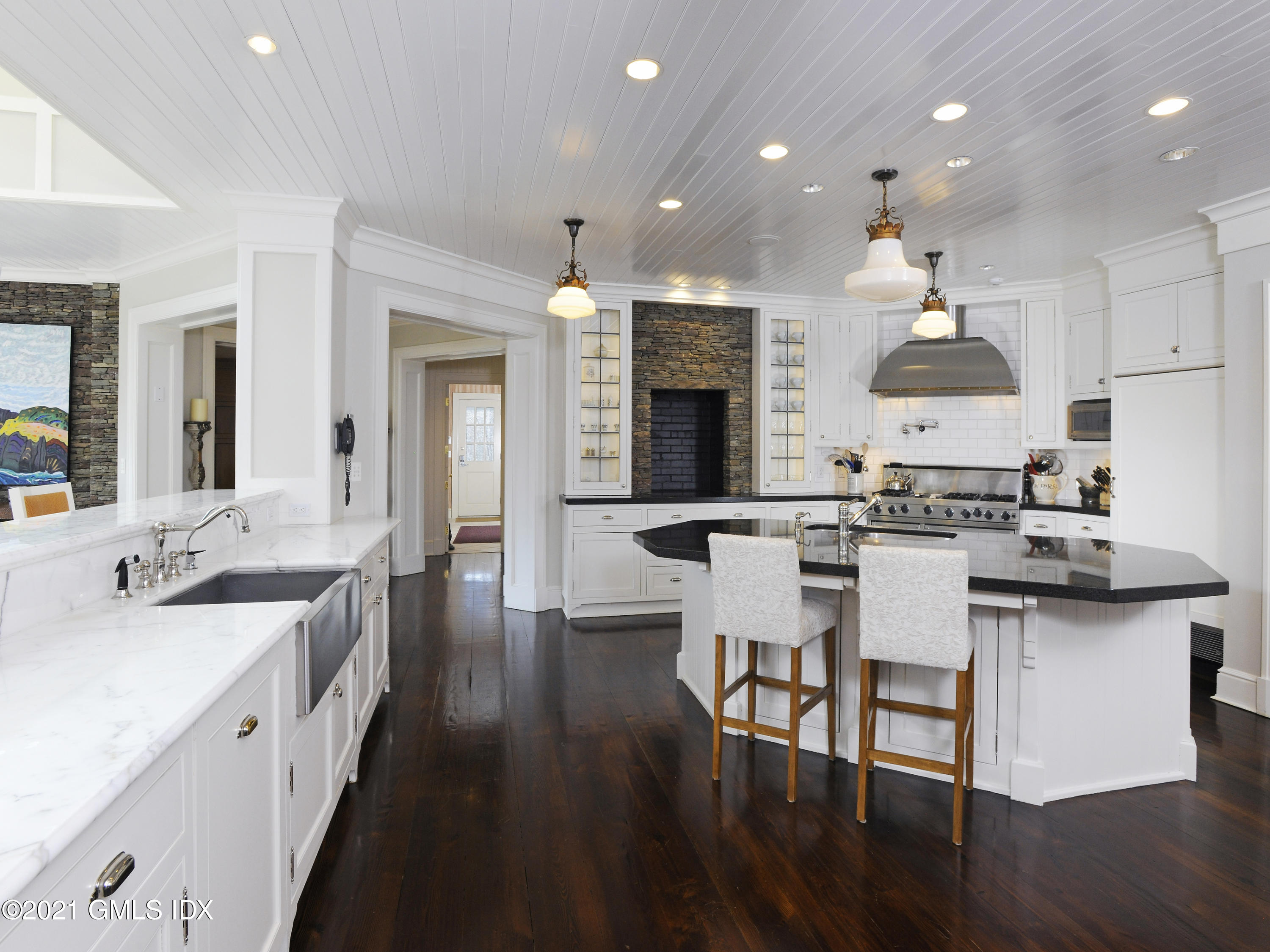 74 Upper Cross Road Greenwich, CT 06831 - Photo 14 of 40 a open kitchen with stainless steel appliances granite countertop a stove top oven a sink dishwasher and white cabinets with wooden floor