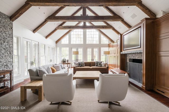 a living room with furniture a fireplace and a large window