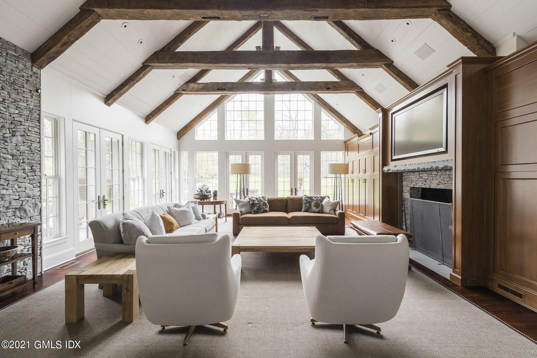 74 Upper Cross Road Greenwich, CT 06831 - Photo 19 of 40 a living room with furniture a fireplace and a large window