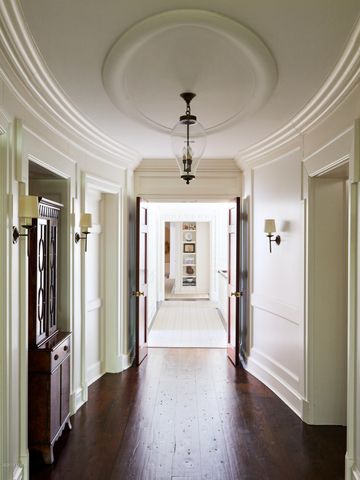 a view of a hallway with wooden floor and windows