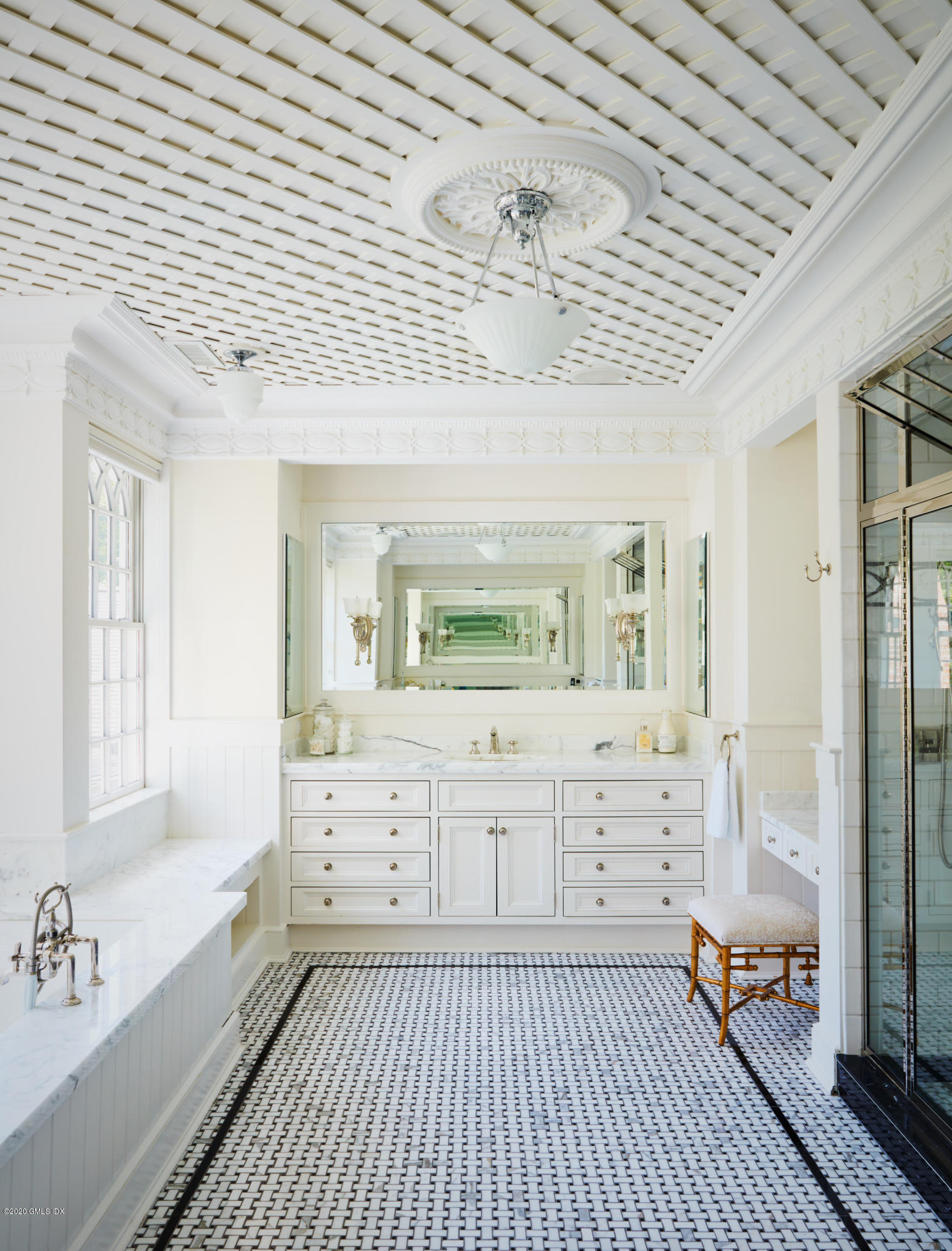 74 Upper Cross Road Greenwich, CT 06831 - Photo 24 of 40 a bathroom with a sink a mirror and a bathtub