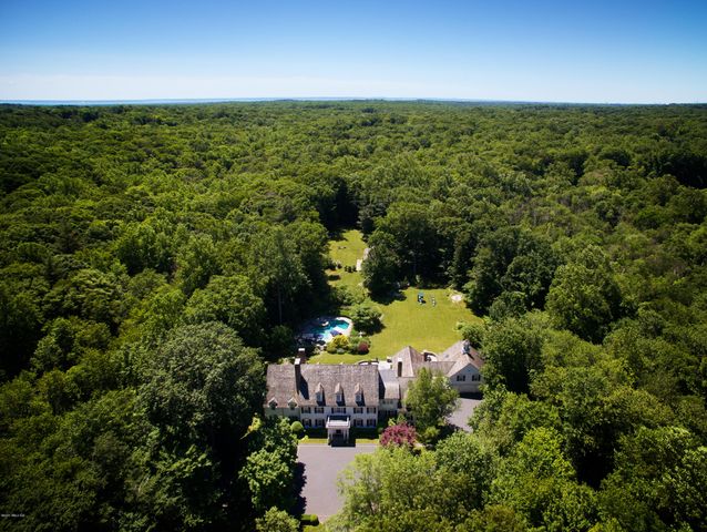 an aerial view of a house with a yard