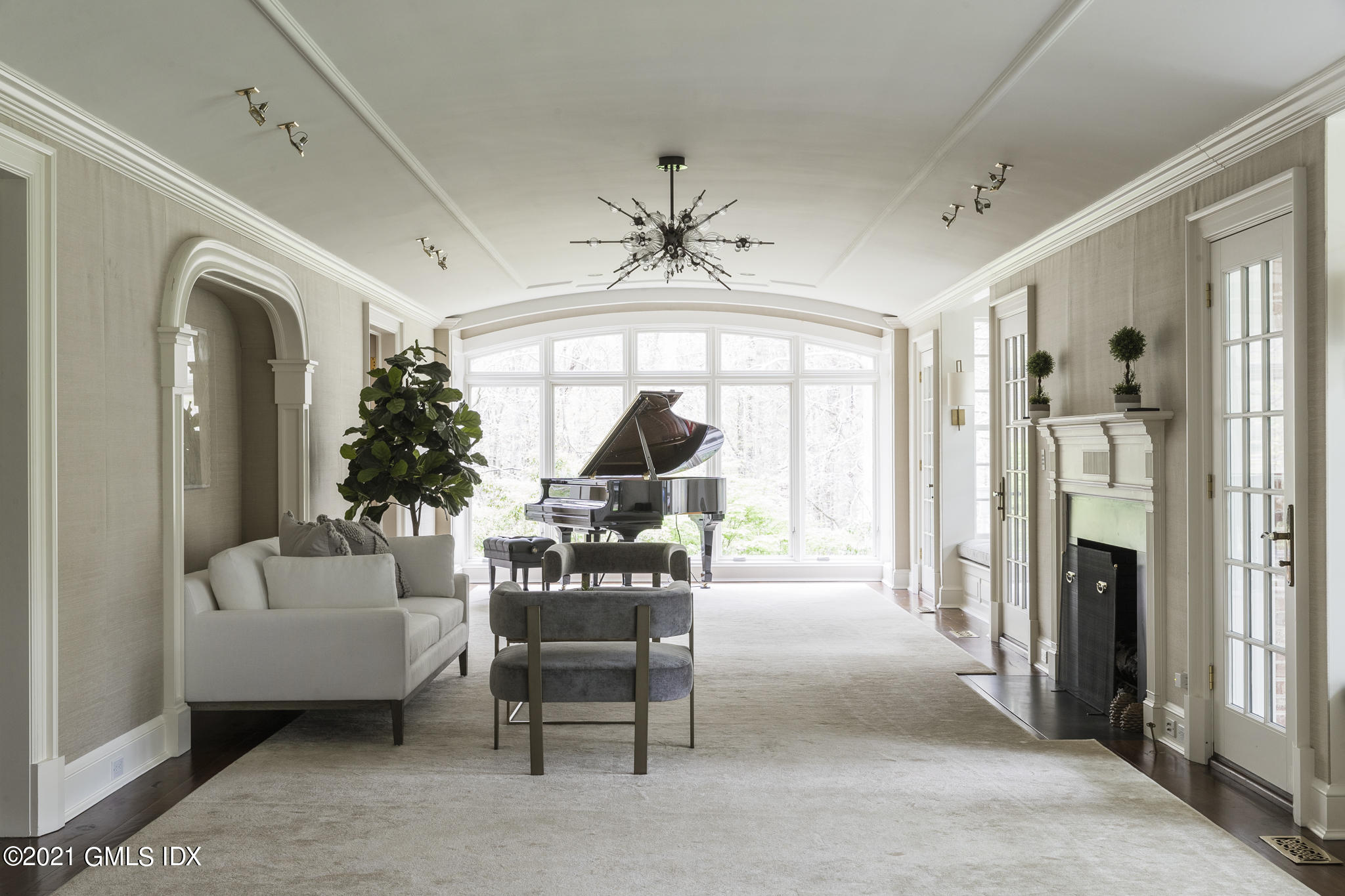 74 Upper Cross Road Greenwich, CT 06831 - Photo 10 of 40 a living room with furniture a fireplace and a chandelier