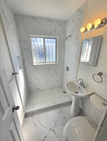 a room with a refrigerator and a stove top oven