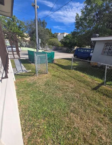 a view of a lake with a bench in patio